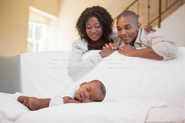 Baby boy sleeping peacefully on couch watched by parents Stock photo © wavebreak_media