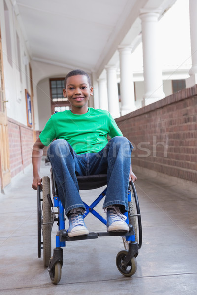 Cute disabled pupil smiling at camera in hall Stock photo © wavebreak_media