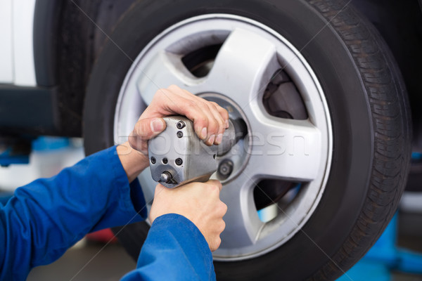 Mechanic adjusting the tire wheel Stock photo © wavebreak_media