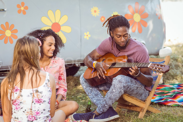 Hipster playing guitar for his friends  Stock photo © wavebreak_media