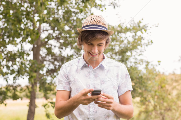 Happy young man using smartphone Stock photo © wavebreak_media