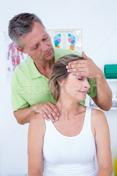 Doctor doing neck adjustment Stock photo © wavebreak_media