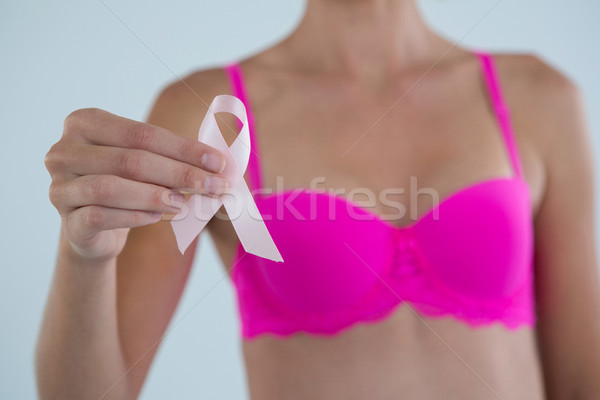 Mid section of woman showing Breast Cancer Awareness ribbon Stock photo © wavebreak_media