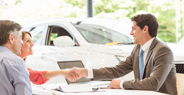Smiling couple buying a new car Stock photo © wavebreak_media