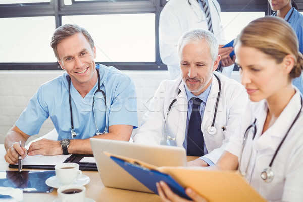 男性医師 笑みを浮かべて 会議室 同僚 ラップトップを使用して ストックフォト © wavebreak_media