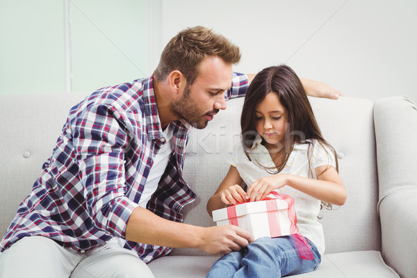 Father helping girl in tying gift box  Stock photo © wavebreak_media