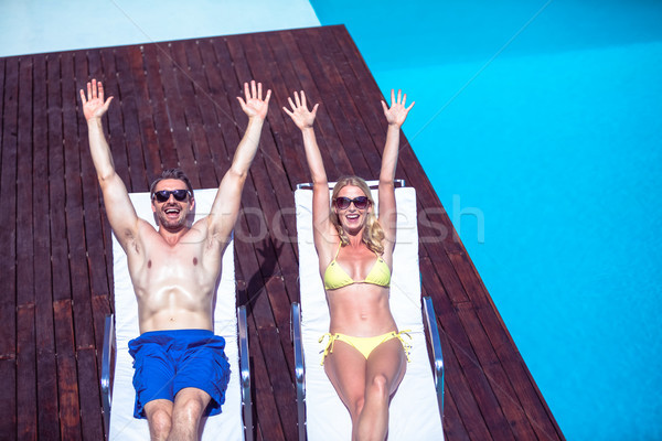 Stock photo: Excited couple relaxing on a sun lounger