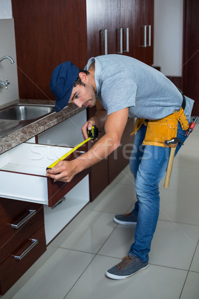 Full length of man measuring drawer size  Stock photo © wavebreak_media