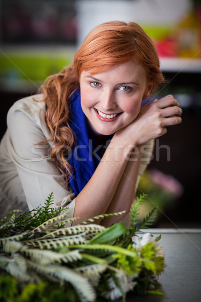 Happy female florist leaning in flower shop Stock photo © wavebreak_media