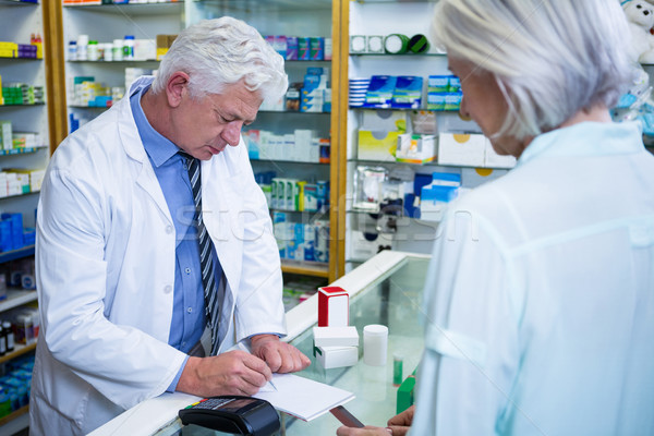 Pharmacist writing prescriptions for medicines Stock photo © wavebreak_media