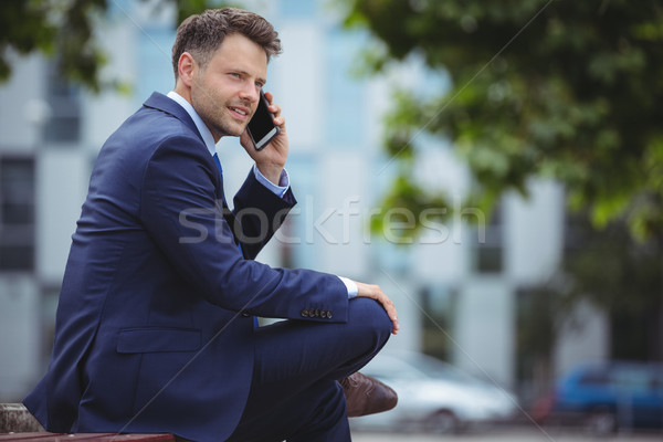 Jóképű üzletember beszél mobiltelefon kívül iroda Stock fotó © wavebreak_media