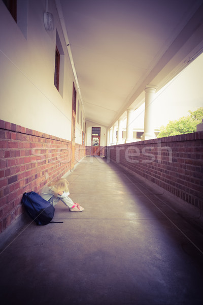 Sad pupil sitting alone on ground Stock photo © wavebreak_media