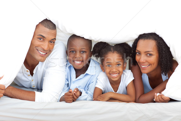 Merry family having fun lying down on bed Stock photo © wavebreak_media