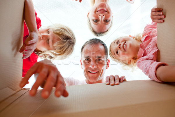 Cheerful family unpacking boxes  Stock photo © wavebreak_media