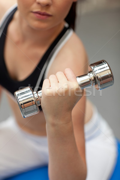 Portrait of a cute woman working out with dumbbells in a fitness center Stock photo © wavebreak_media