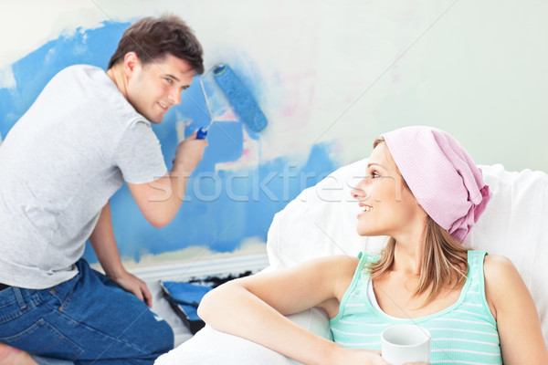 Jolie femme détente canapé copain peinture chambre [[stock_photo]] © wavebreak_media