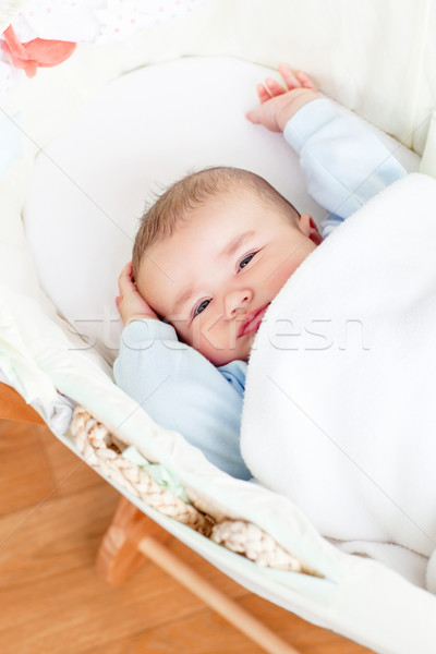 Cute baby boy waking-up lying in his cradle at home Stock photo © wavebreak_media