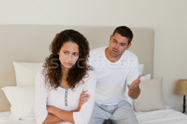 Stock photo: Young couple having a dispute on the bed at home