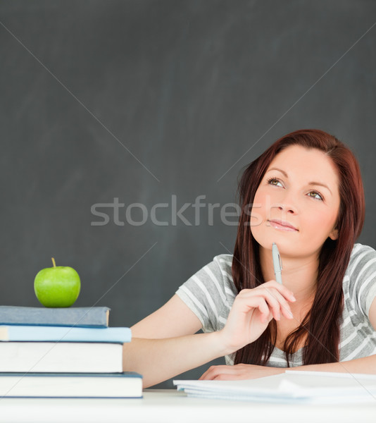 Thoughtful student writting an essay in a classroom Stock photo © wavebreak_media