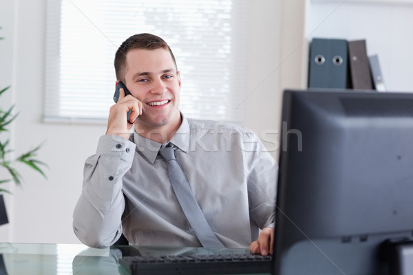 Stock photo: Smiling happy businessman getting pleasant call