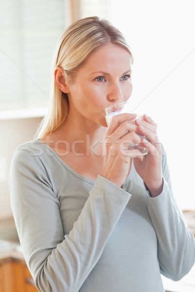 Young woman drinking a glass of water in the kitchen Stock photo © wavebreak_media