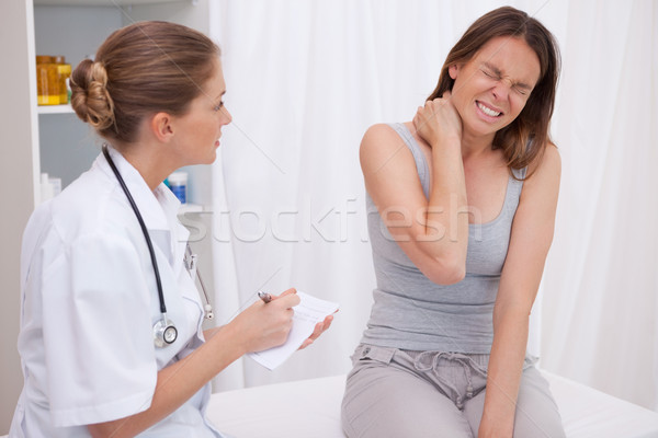 Stock photo: Patient next to doctor having painful shoulder