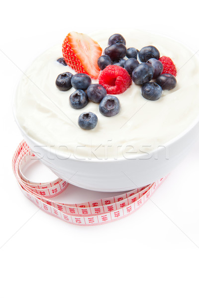 Berries cream with a tape measure against a white background Stock photo © wavebreak_media