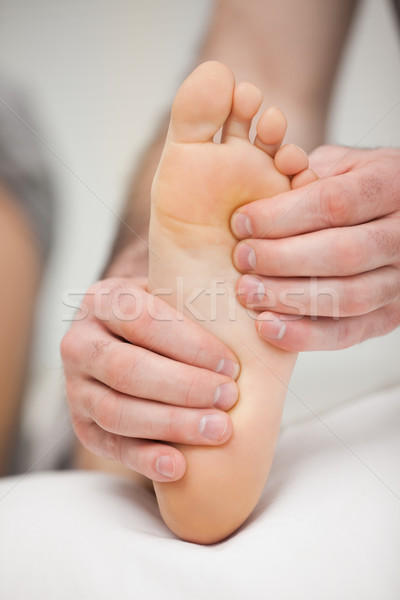 Fingertips touching the sole of a foot in a room Stock photo © wavebreak_media