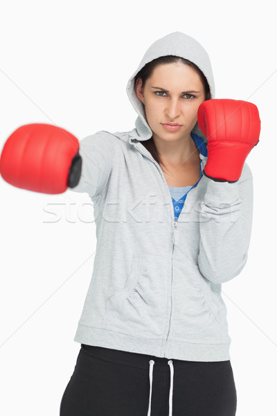 Stock photo: Brown haired woman in sweatshirt boxing against white background