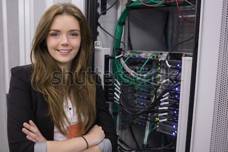 Girl holding cable in front of rack mounted servers in data storage facility  Stock photo © wavebreak_media