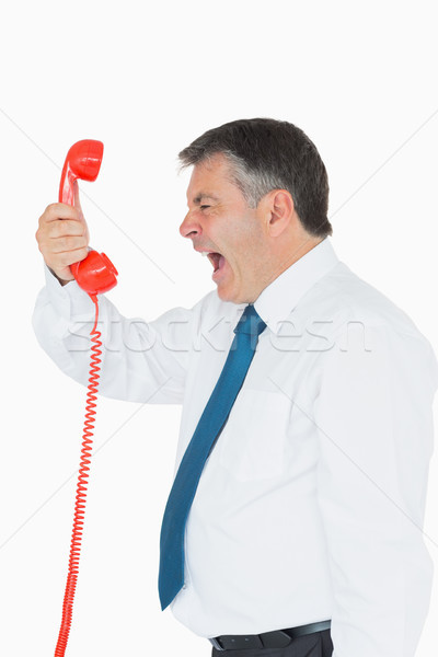 Businessman screaming directly into the red telephone handset  Stock photo © wavebreak_media