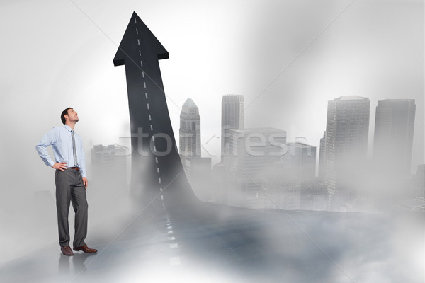 Composite image of smiling businessman with hand on hip Stock photo © wavebreak_media