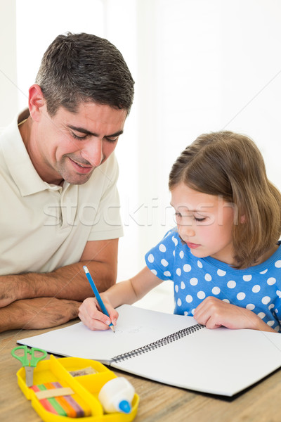 Girl drawing while father sitting by Stock photo © wavebreak_media