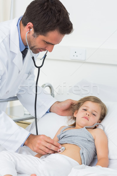 Doctor examining stomach of sick girl  Stock photo © wavebreak_media