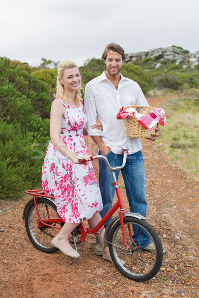 Cute couple going for a picnic smiling at camera Stock photo © wavebreak_media