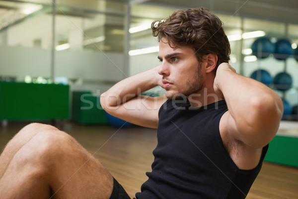 Fit handsome man doing sit ups in fitness studio Stock photo © wavebreak_media