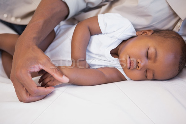 Happy father napping with baby son on couch Stock photo © wavebreak_media