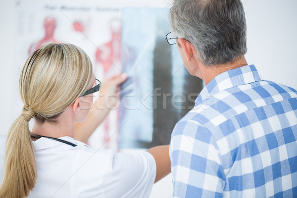 Doctor showing X rays to her patient  Stock photo © wavebreak_media