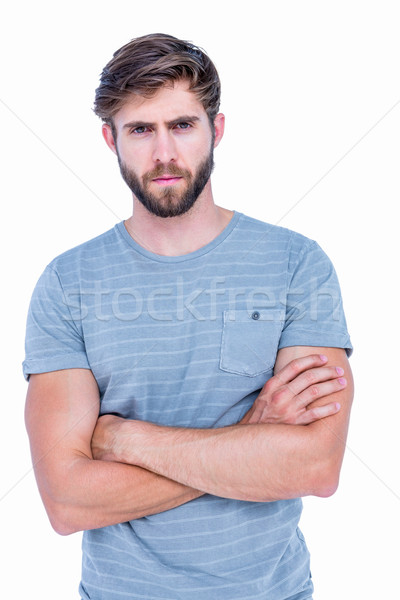 Unhappy handsome man looking at camera with arms crossed  Stock photo © wavebreak_media