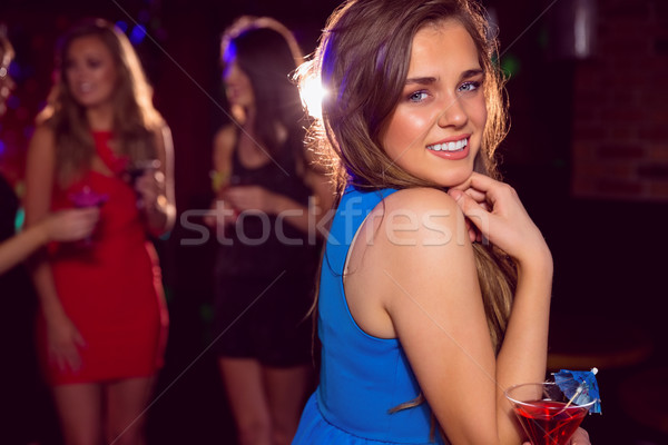 Pretty girl drinking a cocktail Stock photo © wavebreak_media
