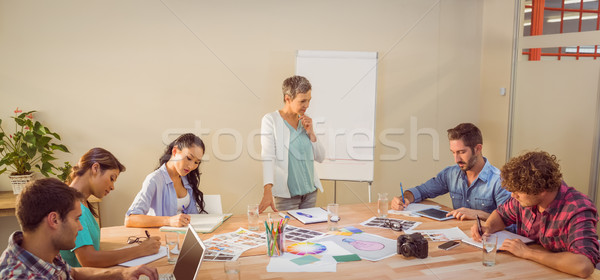 Femme d'affaires présentation collègues jeunes portable [[stock_photo]] © wavebreak_media