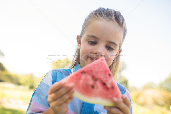Stock photo: Smiling girl looking at watermelon slice in the park