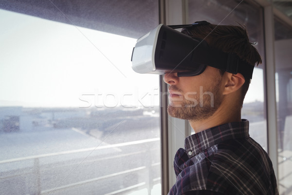 Young businessman wearing vr headset by window in office Stock photo © wavebreak_media