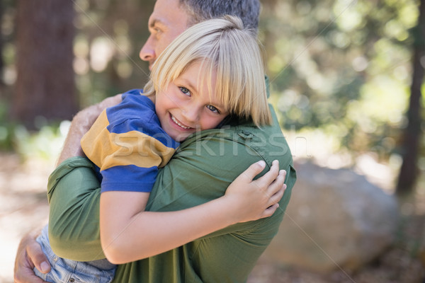 Smiling boy embracing father in forest Stock photo © wavebreak_media