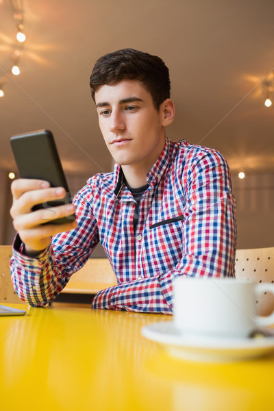 Stock photo: Low angle view of young man using mobile phone