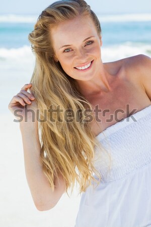 Beautiful young woman sitting on bed at home Stock photo © wavebreak_media