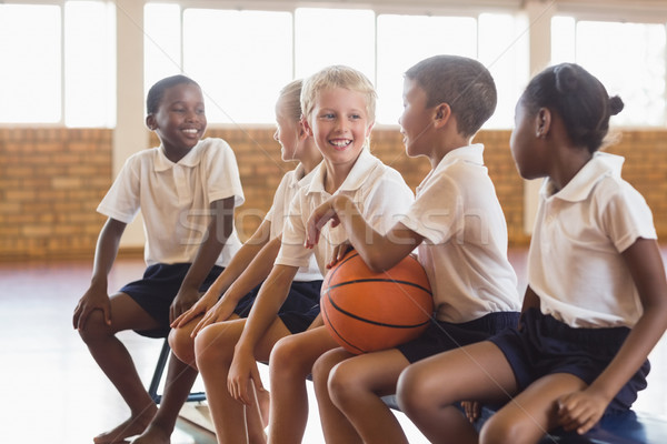 Stock photo: Students sitting on bench talking with each other