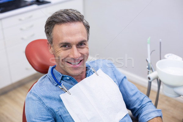 Smiling female patient sitting on dentist chair Stock photo © wavebreak_media