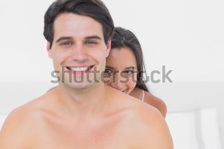 Souriant couple séance lit blanche jeunes [[stock_photo]] © wavebreak_media