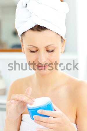 Jól kinéző fiatal nő törölköző bőr krém fehér Stock fotó © wavebreak_media